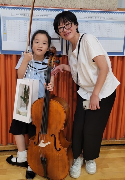 황지윤(1학년) 학생에게 어머니가 축하 인사를 건네며 기념사진을 촬영했다..